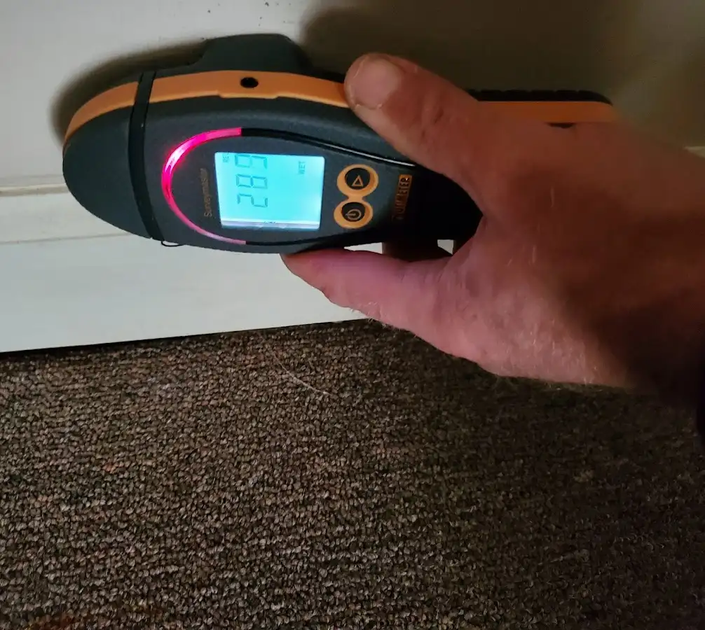 Moisture detection at baseboard during Storm Damage Restoration in Rockport